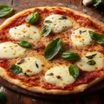 Freshly baked almond flour pizza crust topped with mozzarella and basil